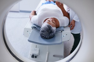 Woman entering cyclotron for scan and diagnosis